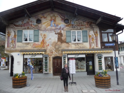 In front of one of the shops with its pretty painted frescoes