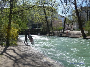 Surfer getting out of water on the Eisbach River