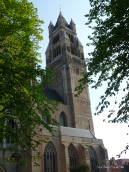 Bruges - spire among the trees