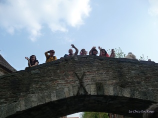 Passers by waving on the bridge